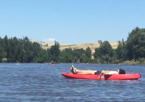 sleeper on river in kayak