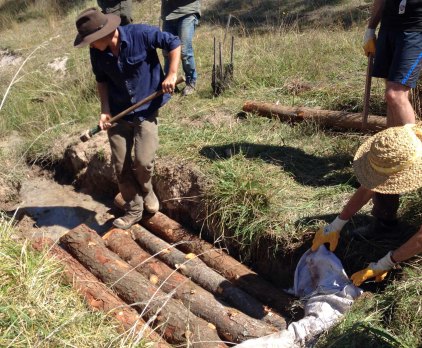 Cam smacking first layer of logs into place