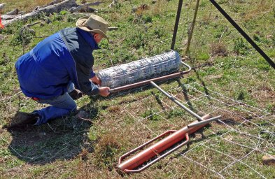 Andrew Leonard laying out temporary fence